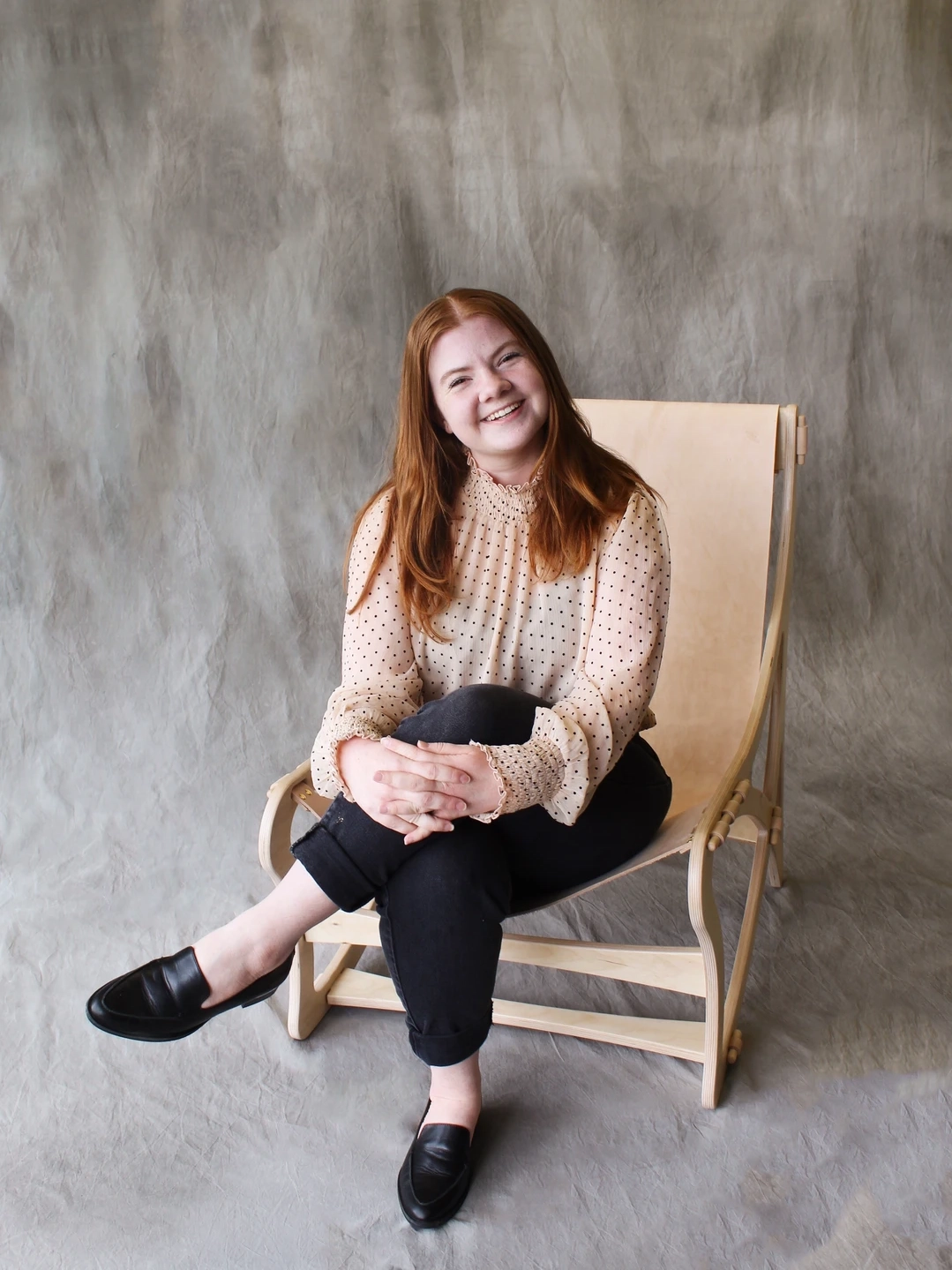 Ainsley Bauer sitting in her wooden chair