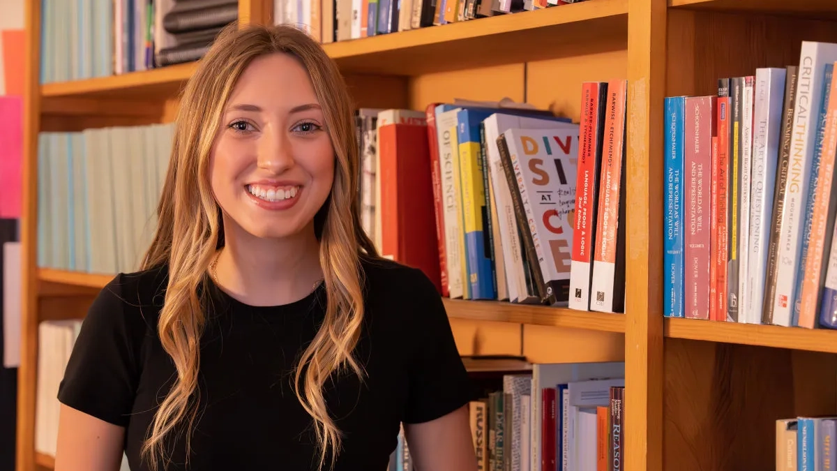 Woman standing in front of bookshelves