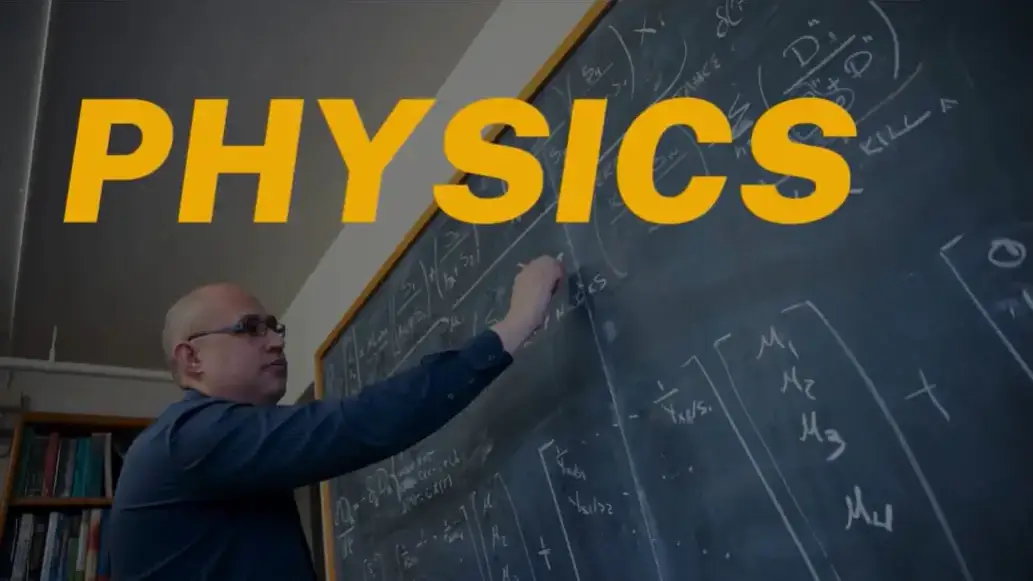 Physics thumbnail of a professor writing formulas on a chalkboard.