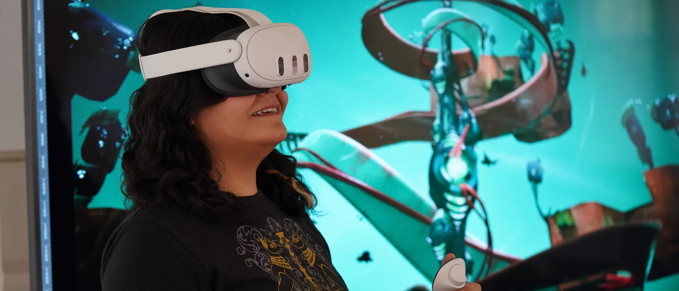 A student wearing a VR headset while holding its controllers.