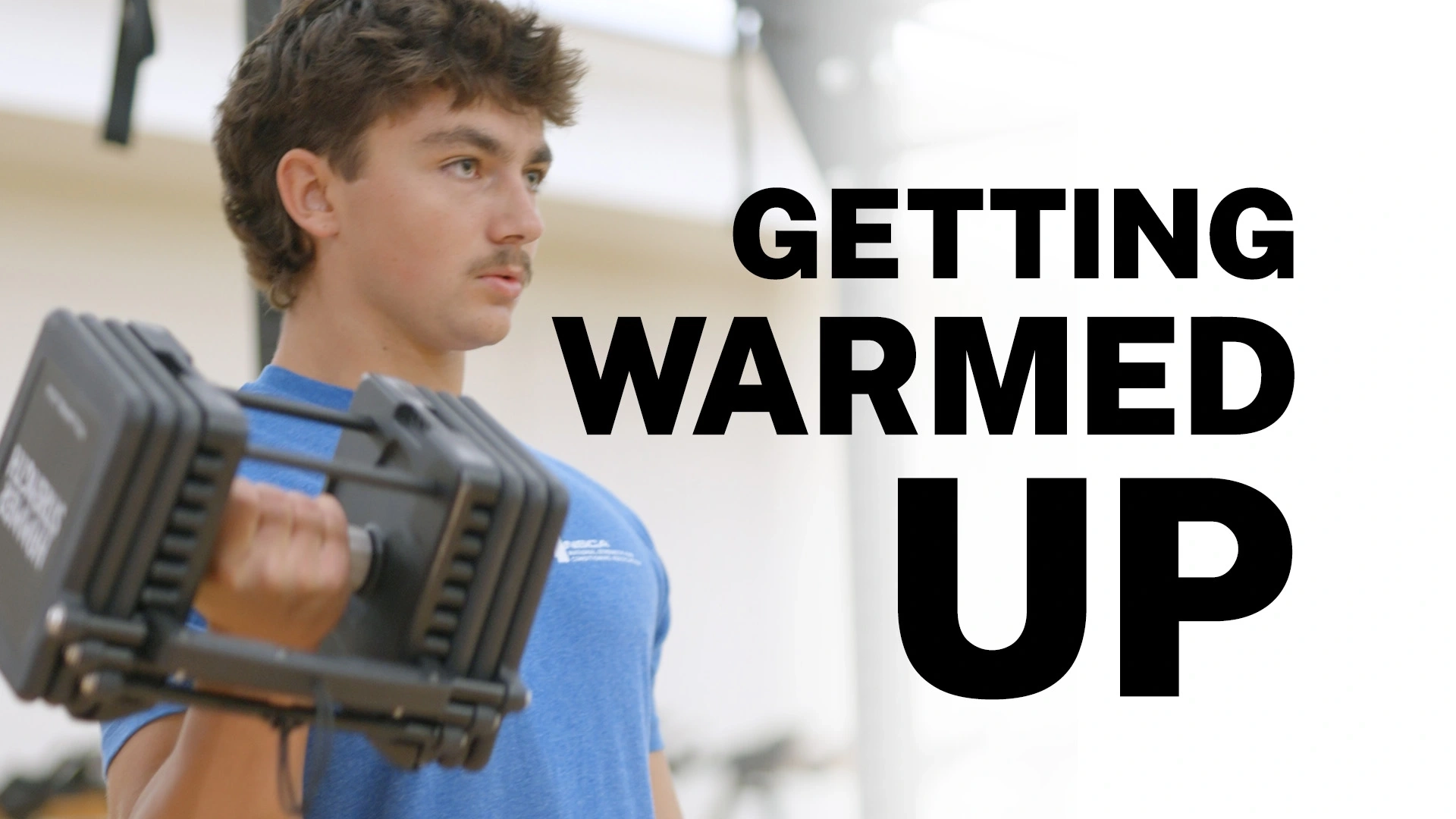 Jared Hanchey lifting weights with text overlay, "Getting warmed up."