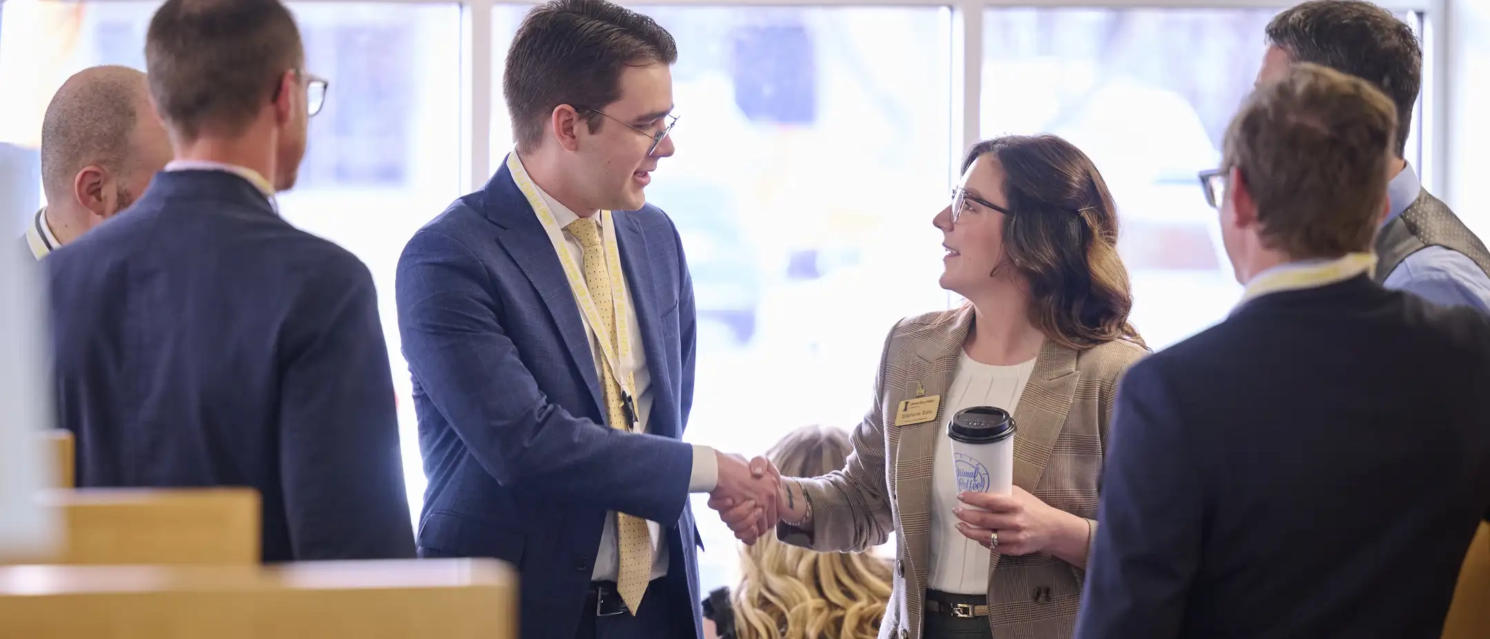 Man and woman shaking hands at Boise center event.