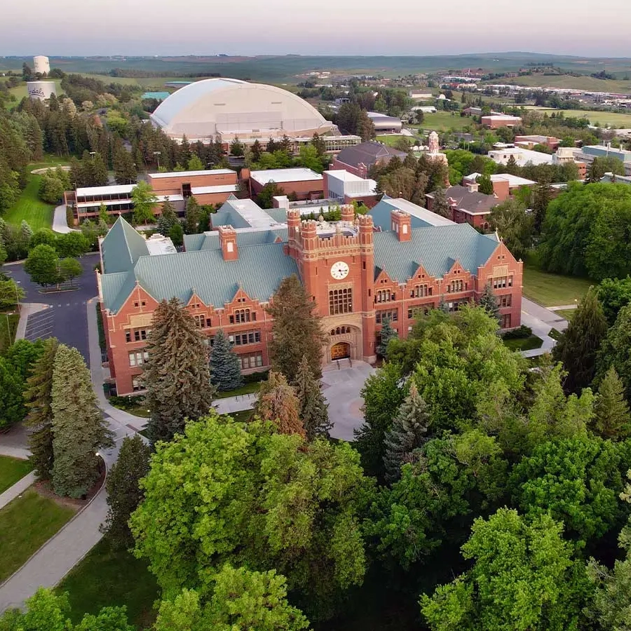 Bird's eye view of UIdaho's Admin Building with campus in the background.