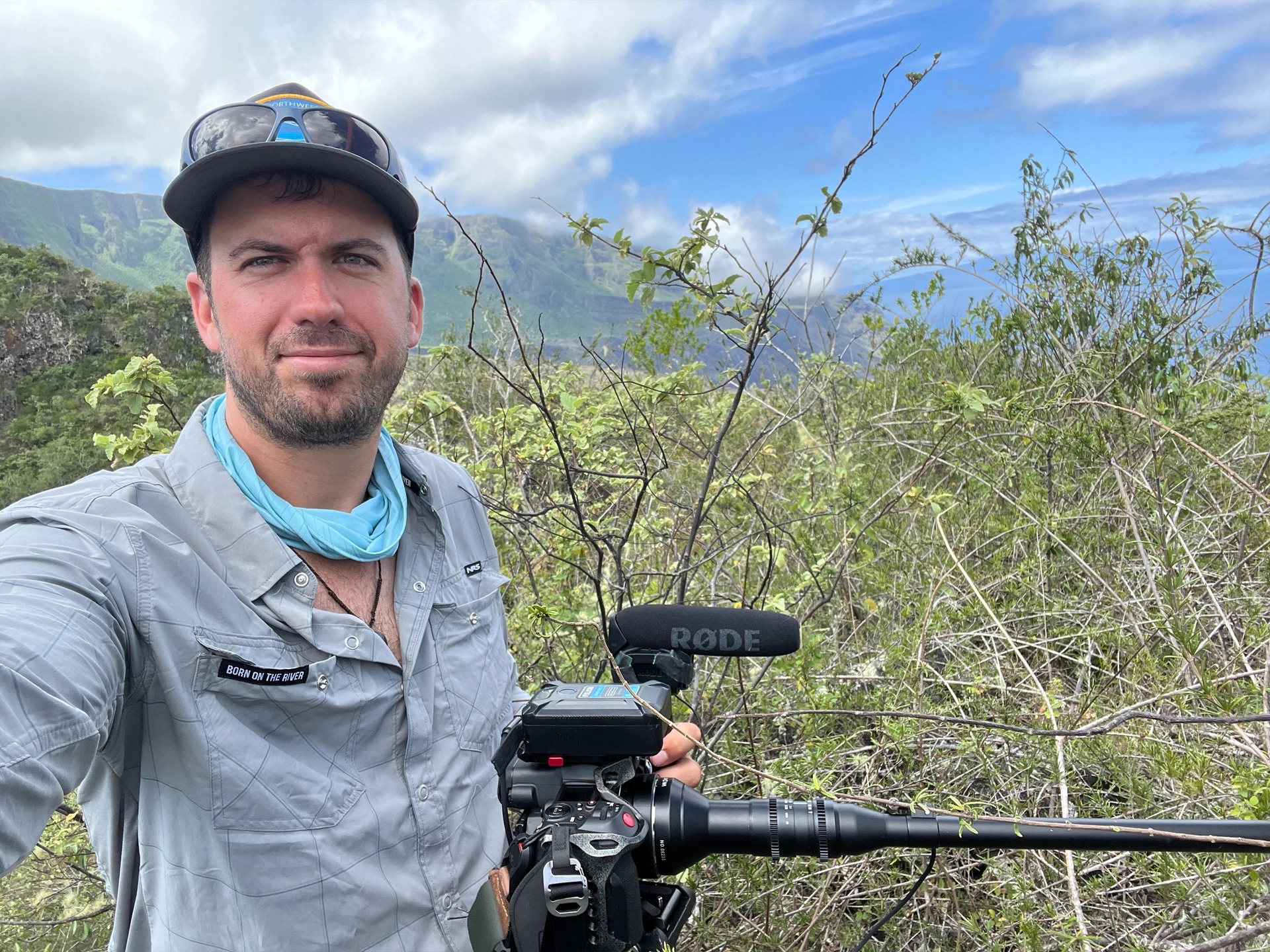 Self portrait of Jim Aikman holding a camera in his other hand