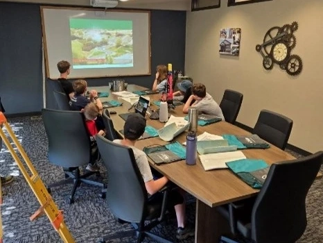 Children in classroom watching transportation presentation