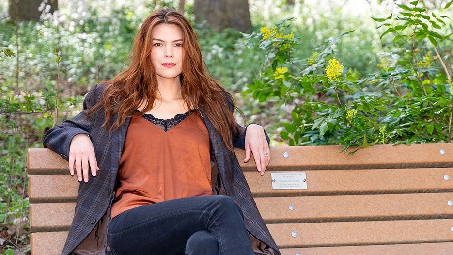 Celilo Miles sits on a bench