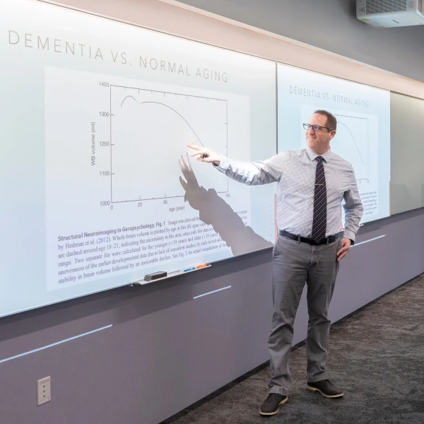 Thomas Farrer points to a data trend on a graph