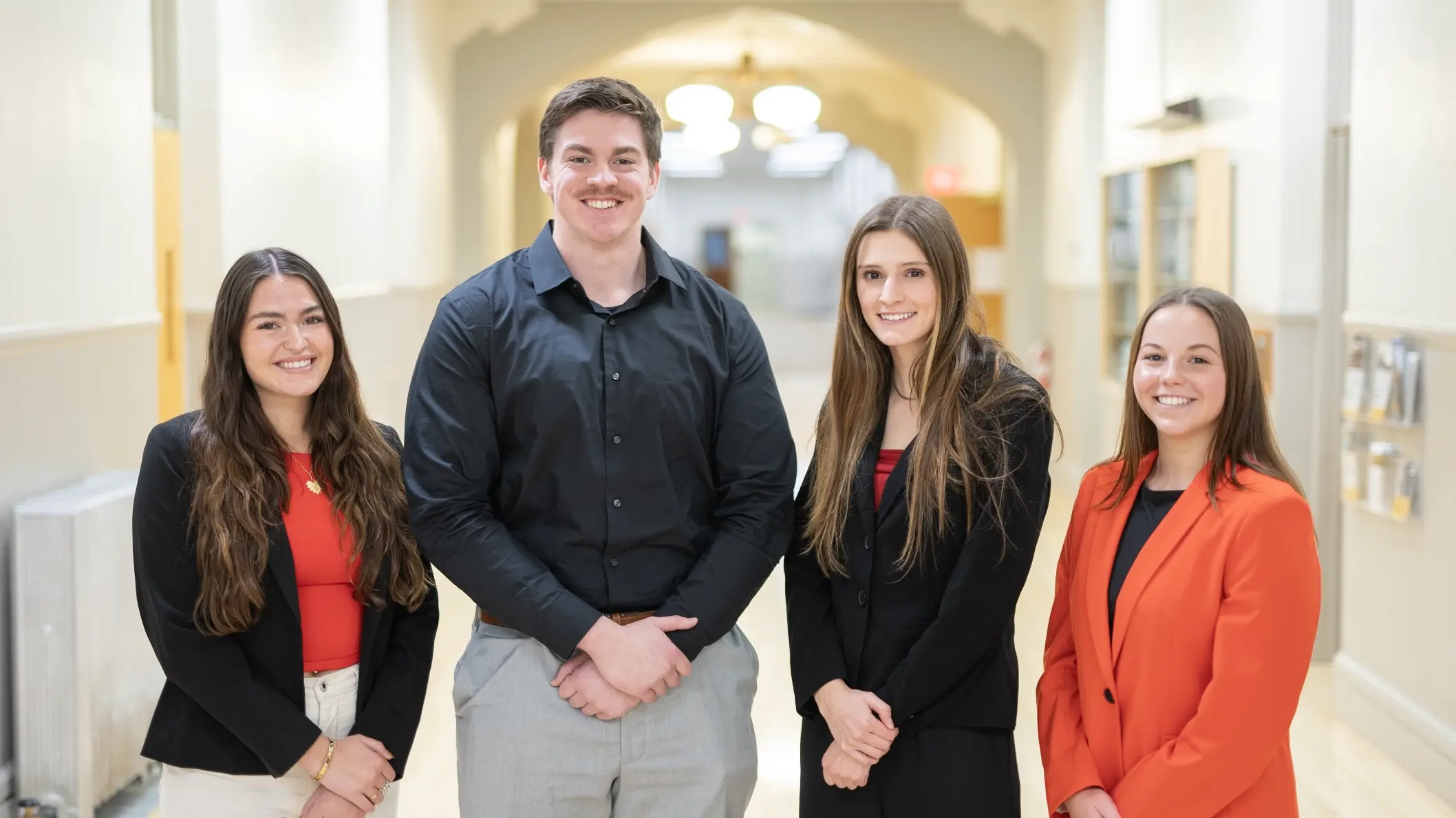 Group photo of Lillie Esson, Kevin Eldredge, Sophia Robertson and Brielle Sorensen in a Moscow school hallway.