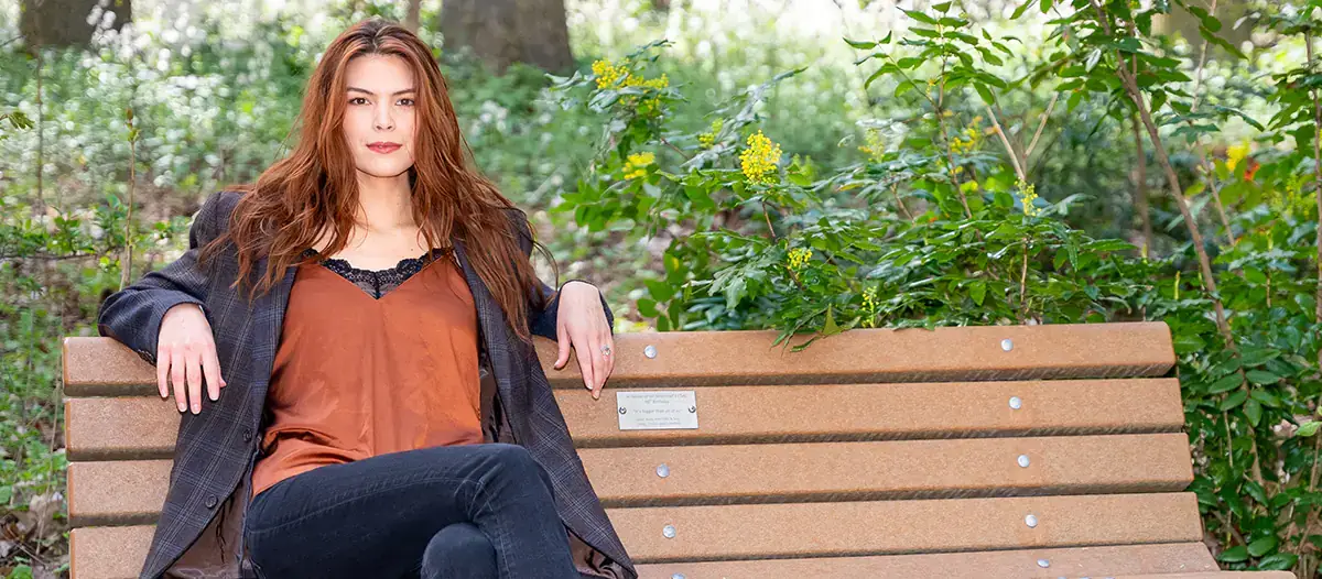 Celilo Miles sits on a bench