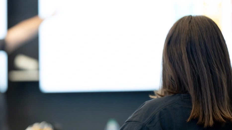 A student sits in front of a screen