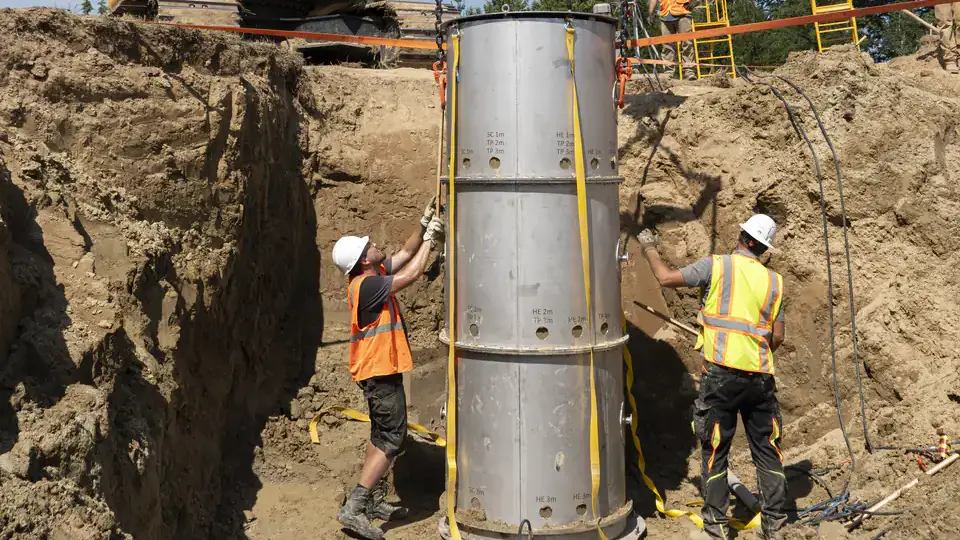 Men in a deep hole setting up the deep soil ecotron.