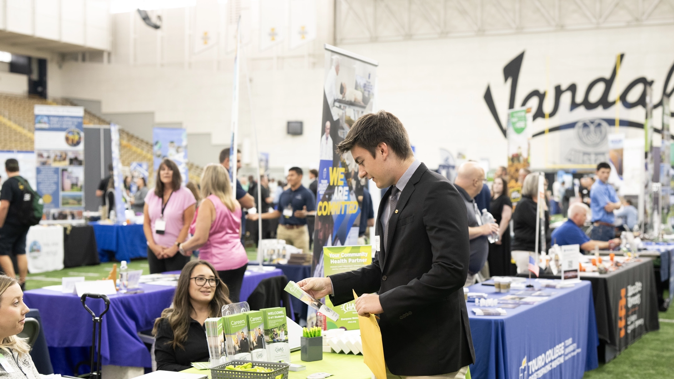 A student talks with an employer at a booth at the Career Fair.