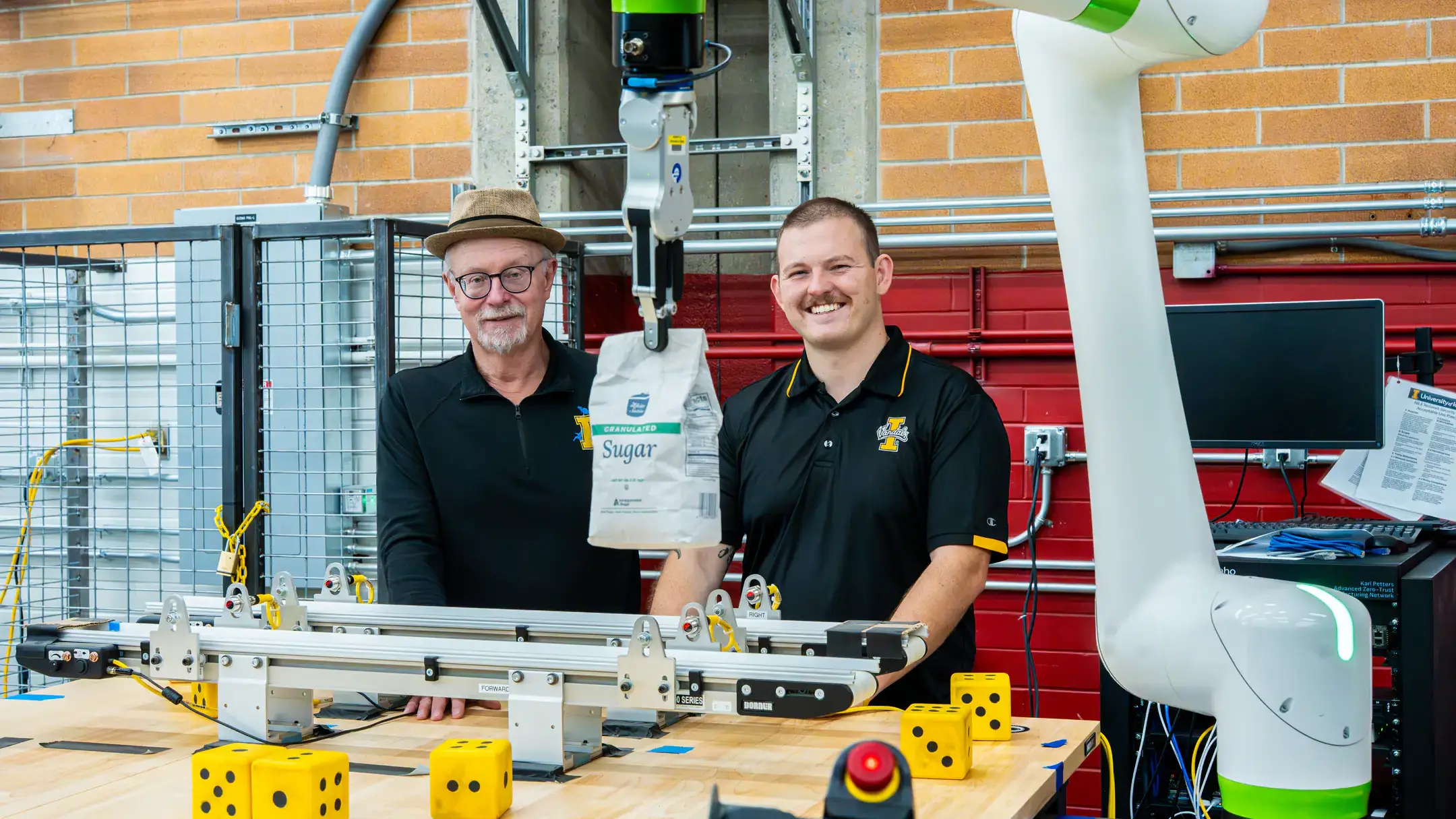 Engineering students and faculty are developing AI-driven automation solutions for Amalgamated Sugar to keep the plant's assembly line from breaking down while adding components to maintain moisture levels in sugar beets, helping the company improve productivity and optimizing both quality and quantity. Pictured from left are computer science graduate student Hunter Hawkins and research faculty John Shovic.