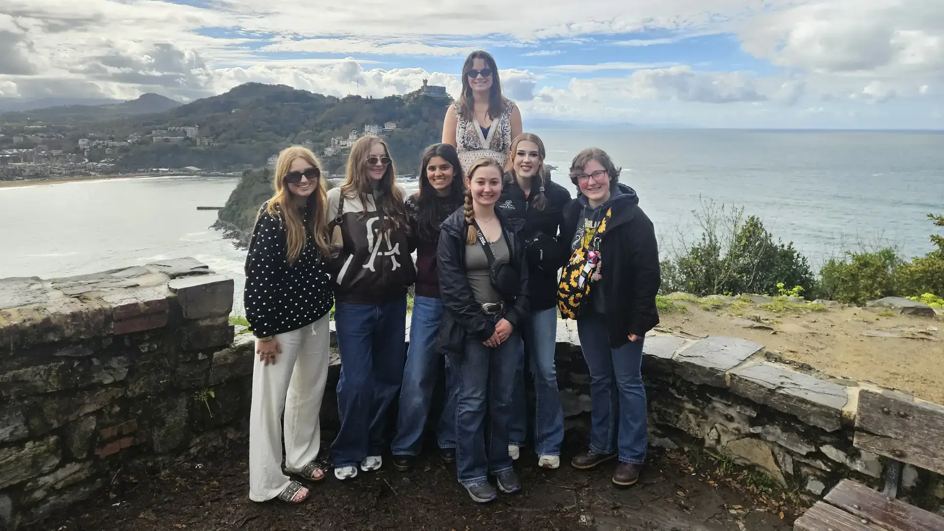 Students pose at a coastal overlook.