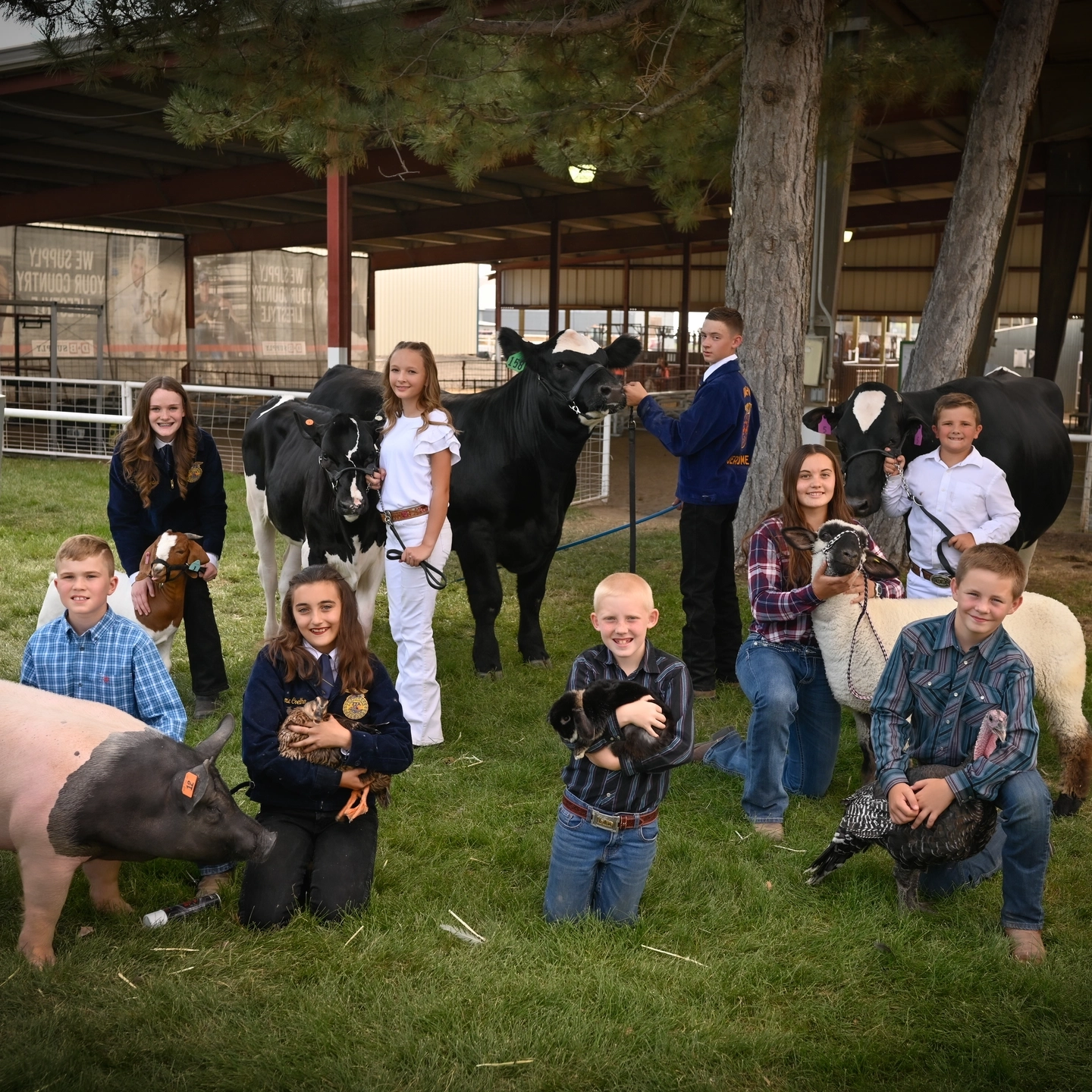 4-H children pose with their show animals.