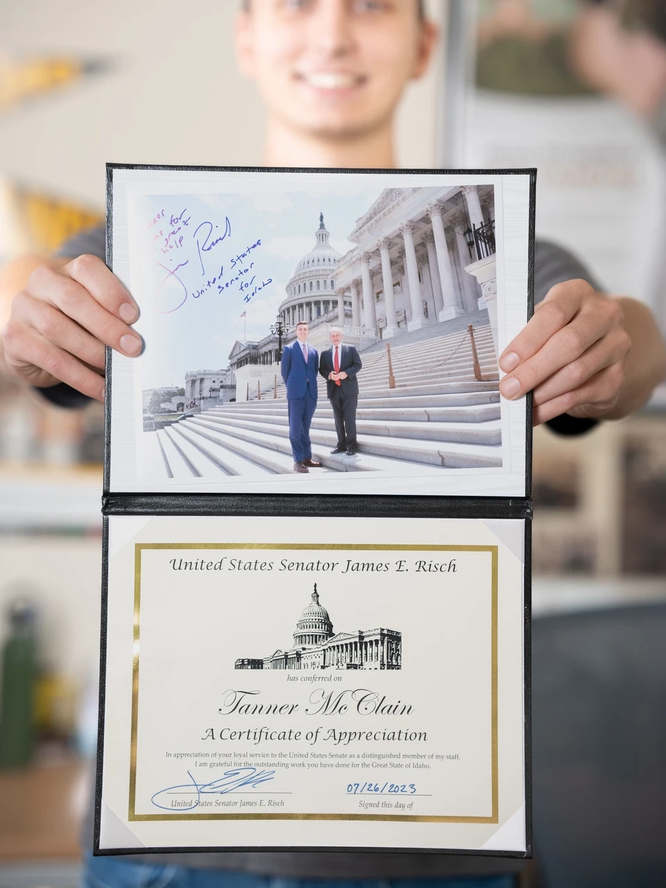 Tanner McClain holding a signed federal certificate 