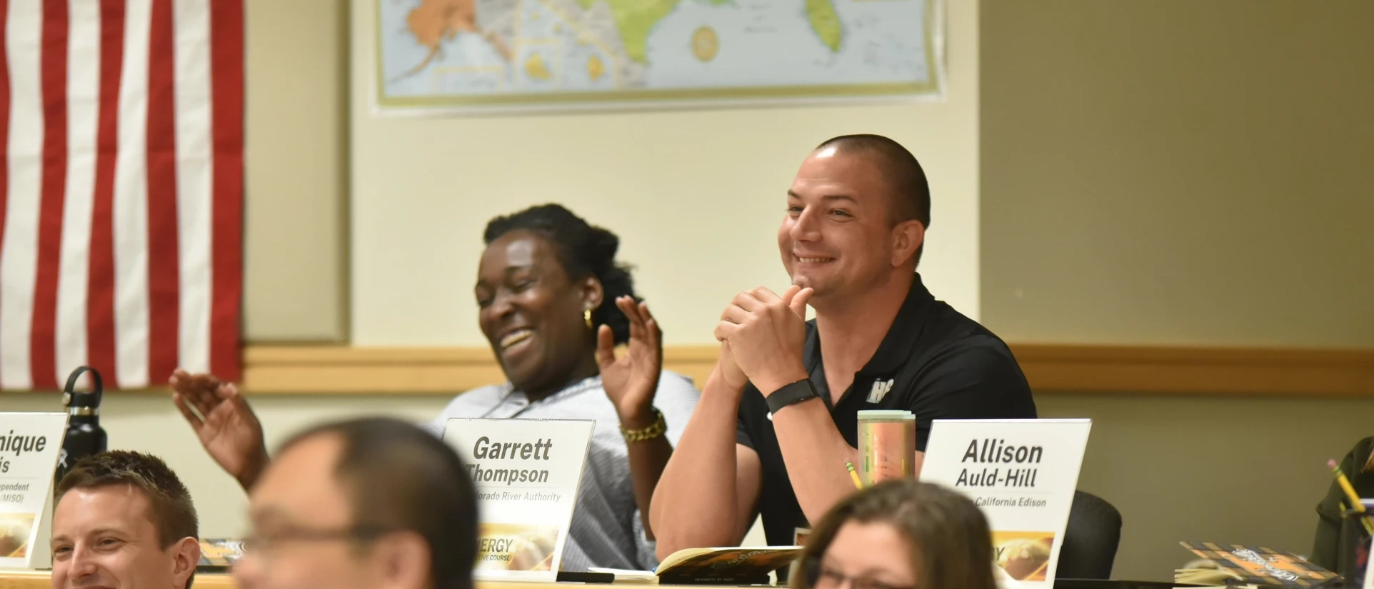 People in a lecture hall smiling.
