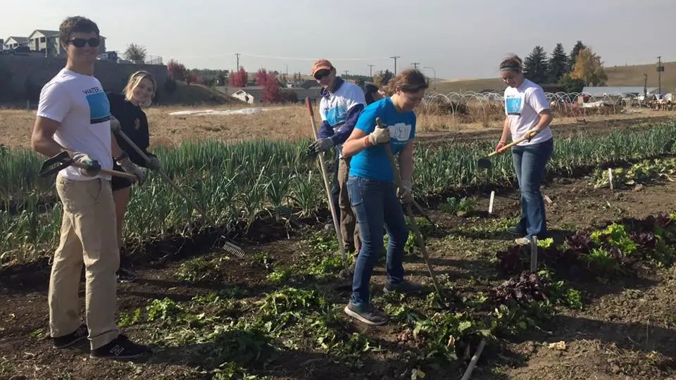 Student working in the garden of the Soil Stewards farm