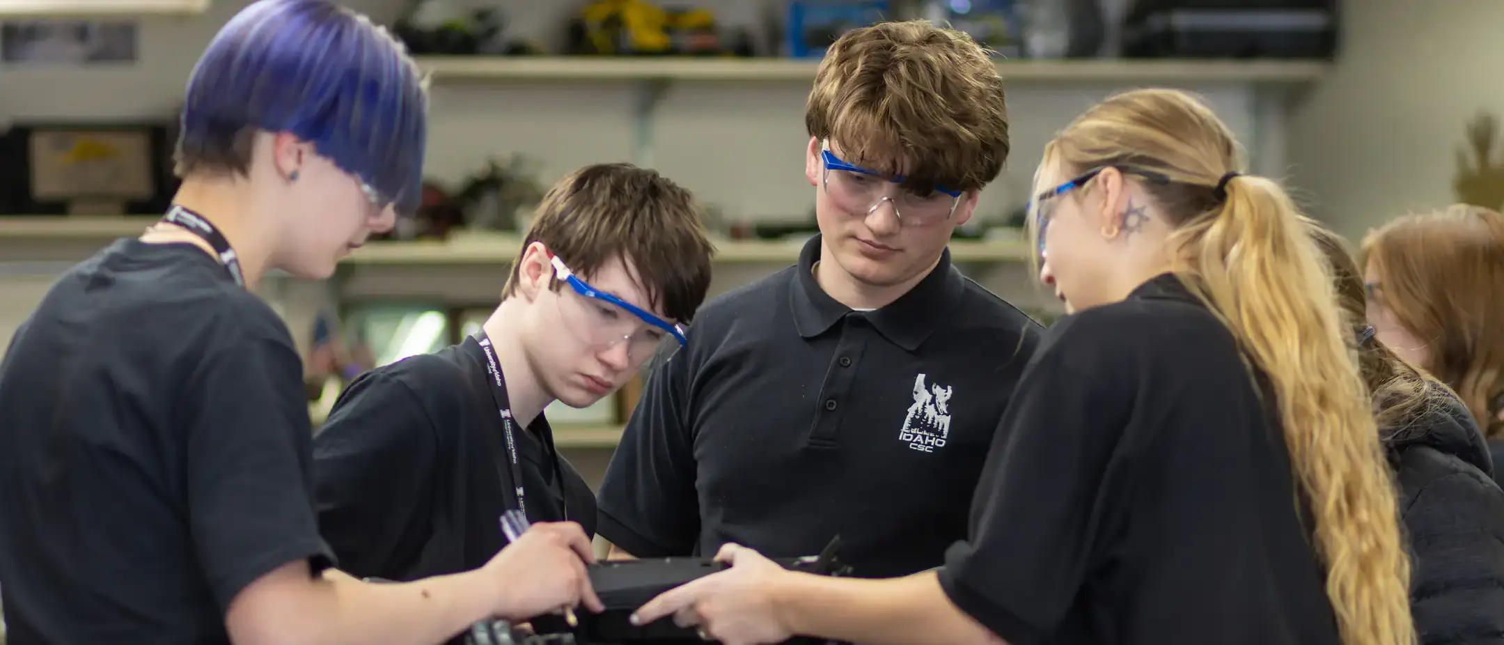 Four students work together on engineering a snowmobile
