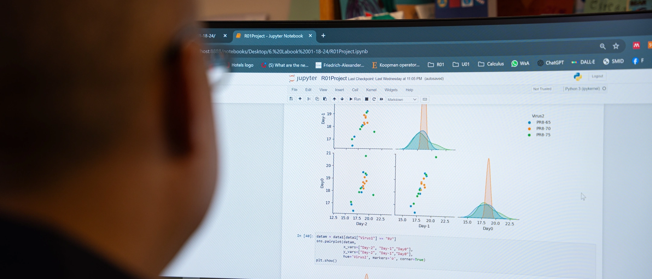 Assistant Professor of Mathematics Esteban Hernandez-Vargas reviews graphs on a computer with data from virologist that will be used to build mathematical models to mitigate viral infections.