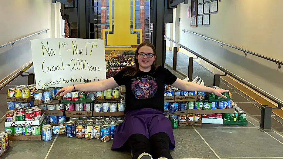 University of Idaho student, Zoe Evans stacks cans of food she purchased for a donation.