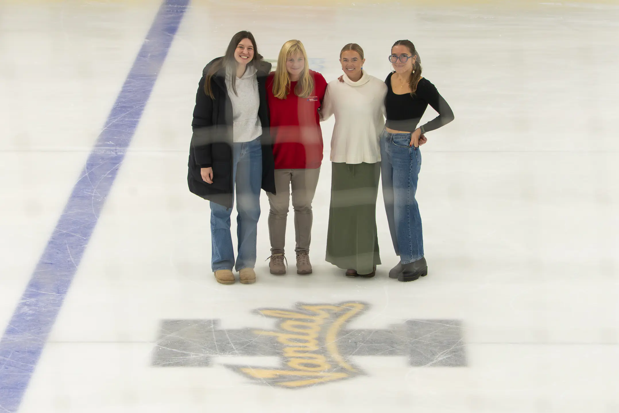 University of Idaho students in the Vandal Solutions program are assisting the Palouse Ice Rink in Moscow, ID with marketing projects. Pictured from left are: Peyton Watson; Laura Wold-Morford, manager of the Palouse Ice Rink; Maggie Meyer, Lucy Bleu McDougald.