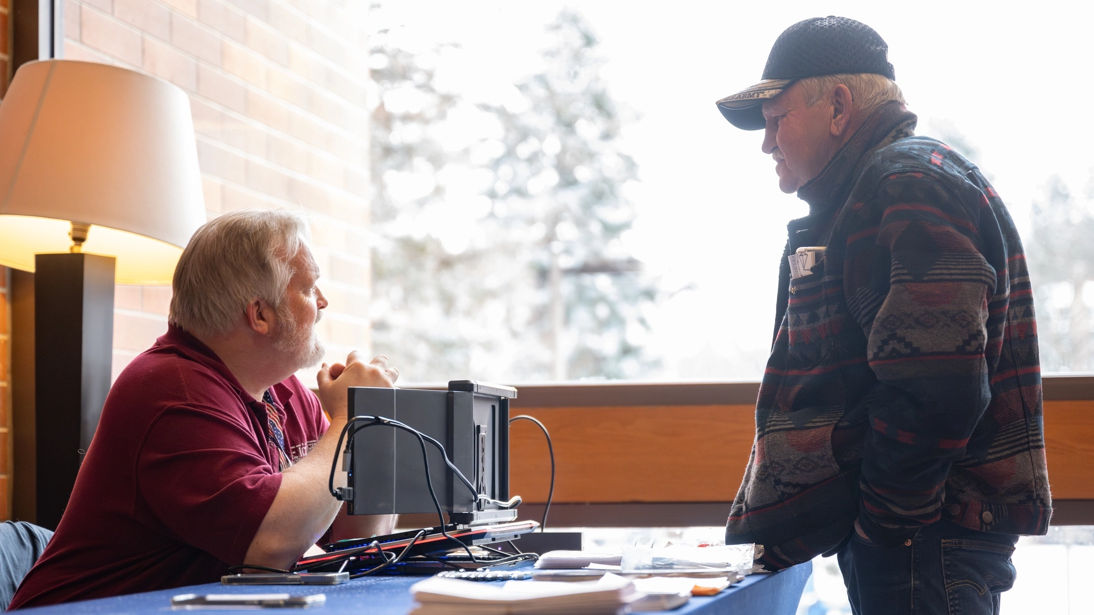 Two men talking together across a table