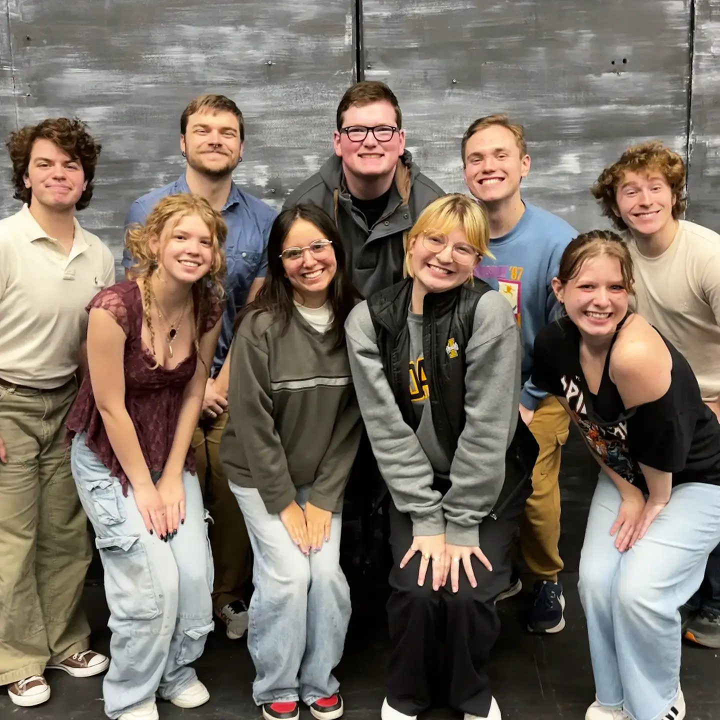 The cast of nine people in University of Idaho’s ‘Ride the Cyclone’ posing for a photo.