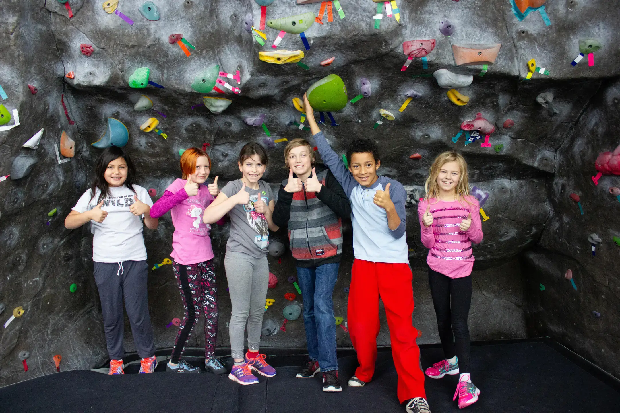 Youth climbers partaking in a rock climbing event