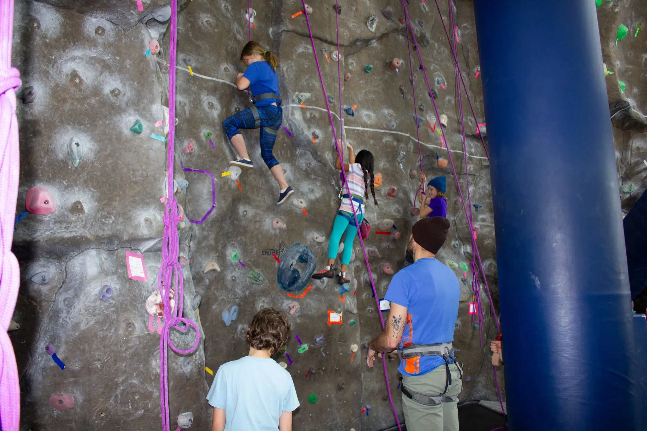 Youth climbers partaking in a rock climbing event