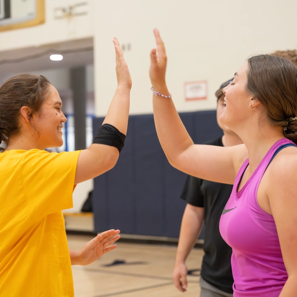 Two teammates high five.