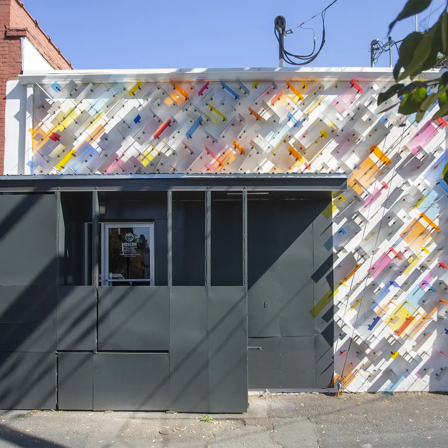A colorful building with black boards in front of the entrance.