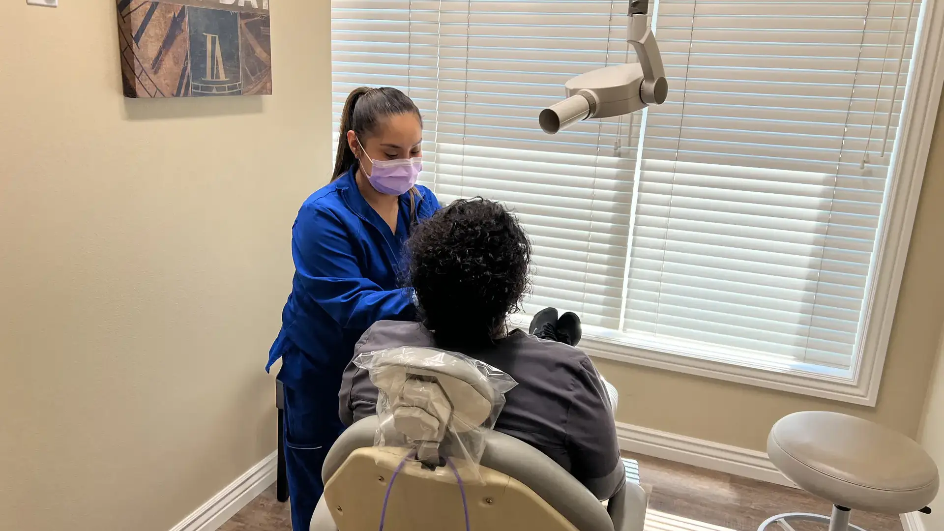 A woman taking dental films of a patient in a dentist office