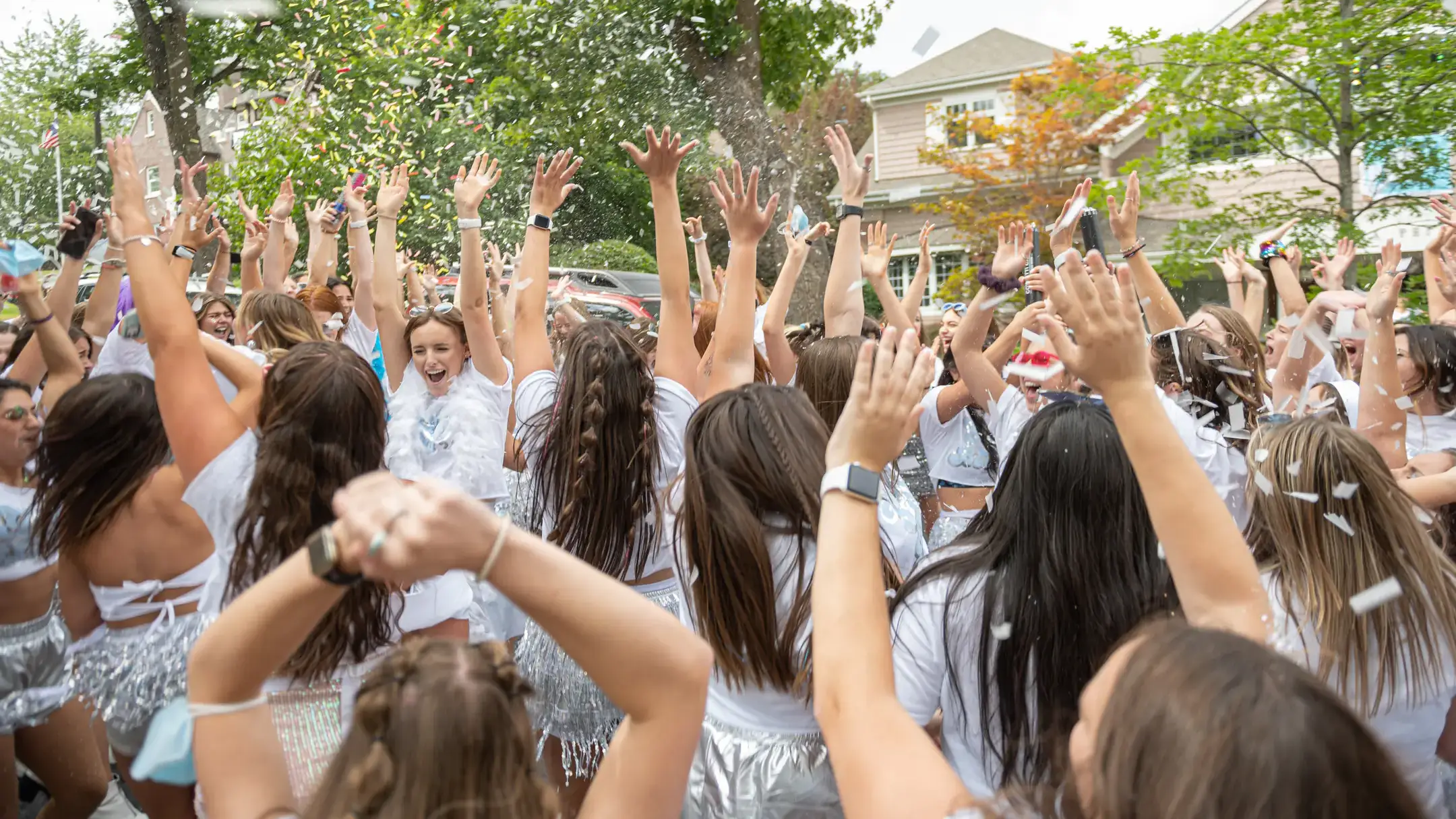 Sorority sisters holding their hands in the air.