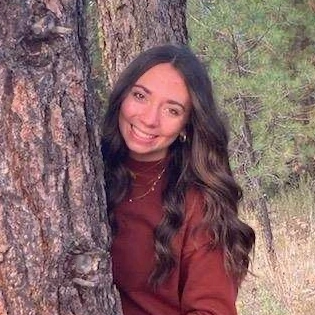 A woman behind a tree