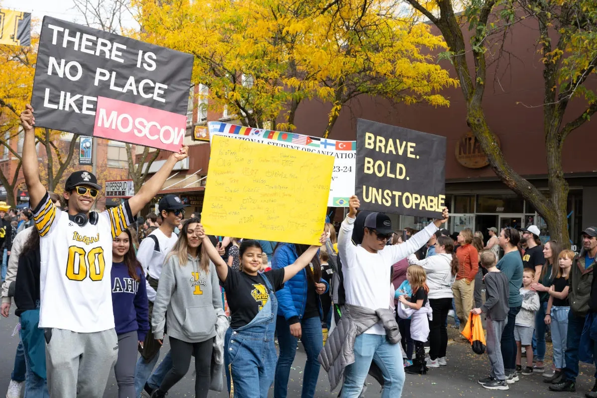 Students marching with banners as part of the 2023 Homecoming parade