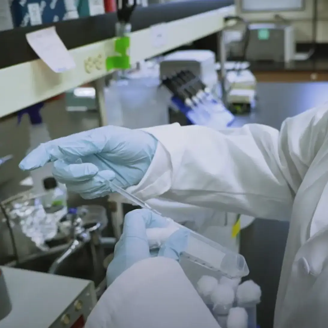 A woman in a lab coat doing an experiment
