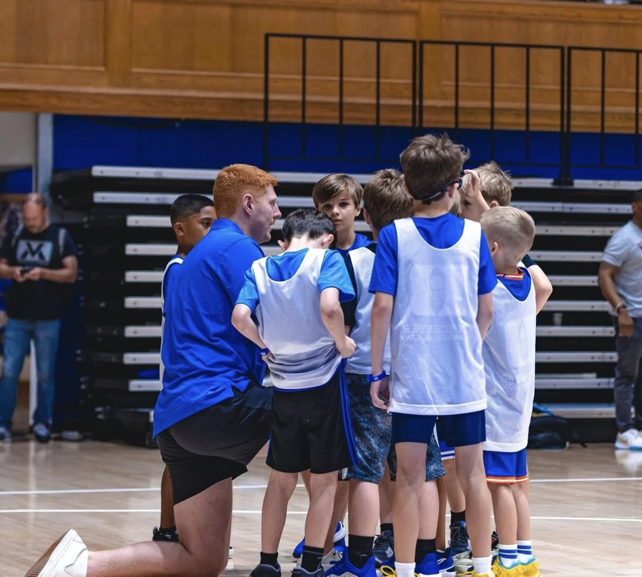 Ryan Collins coaches children at Duke basketball camp. 