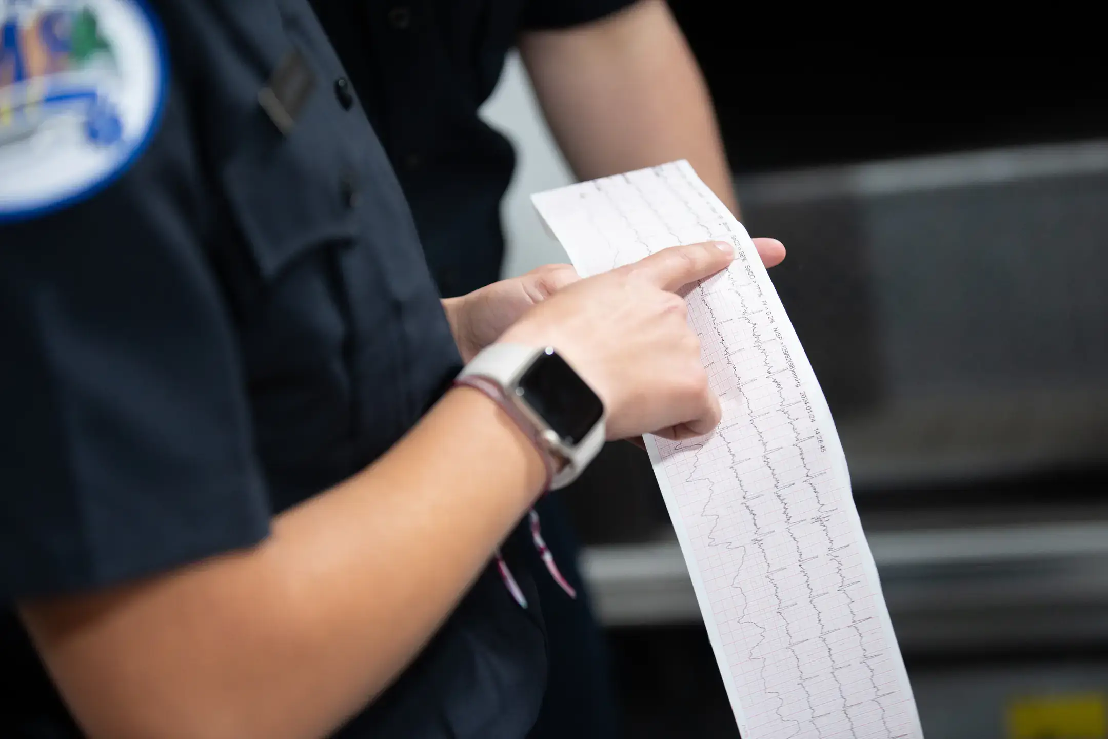 Medical Sciences B.S. student Angel Dominguez reads a printout of patient's health trends, heart rate, SpO2, blood pressure, 4 lead ECG and pleth waveform while working with the Moscow Volunteer Fire Department as a EMT student volunteer.