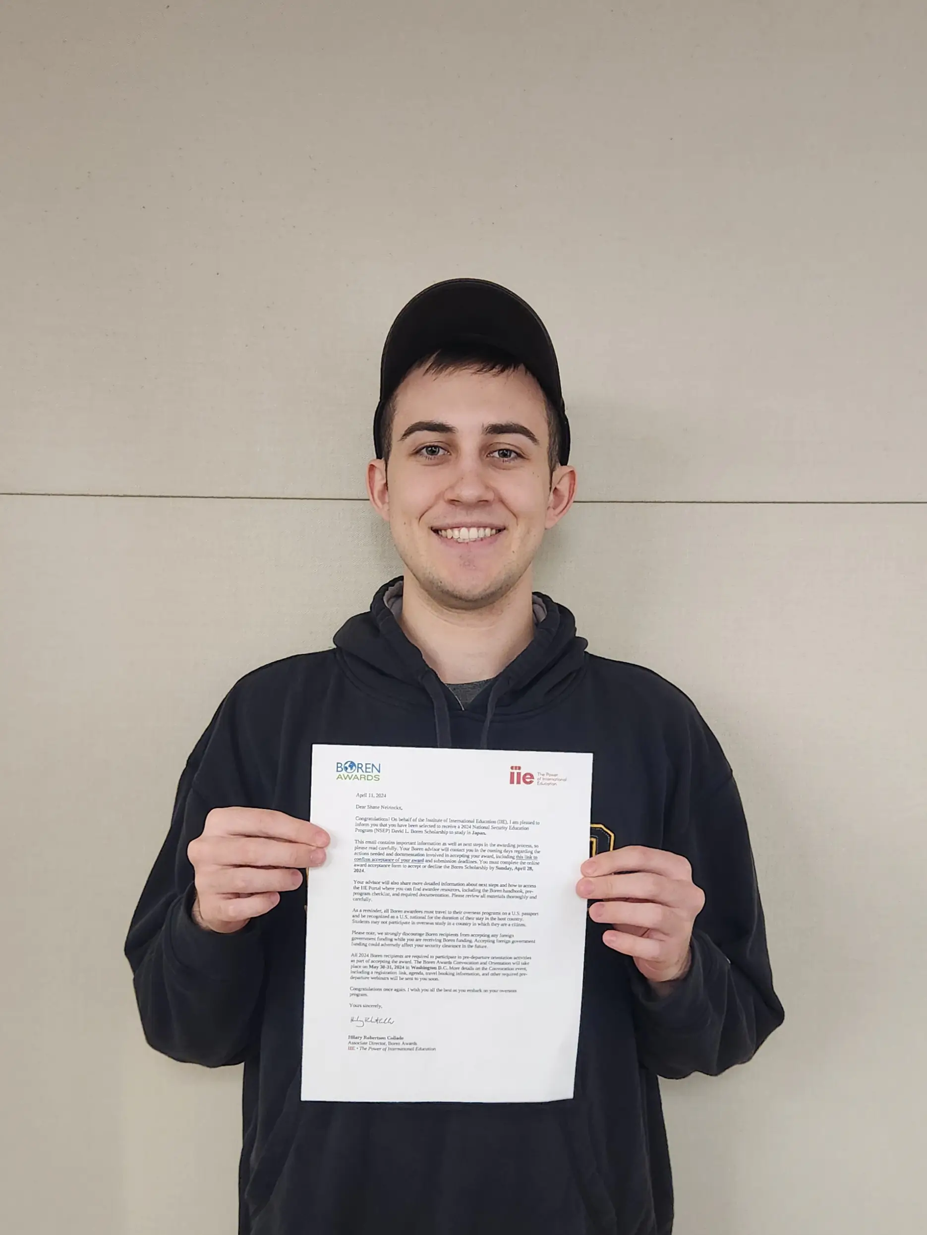 Shane Neirinckx holds his scholarship award letter