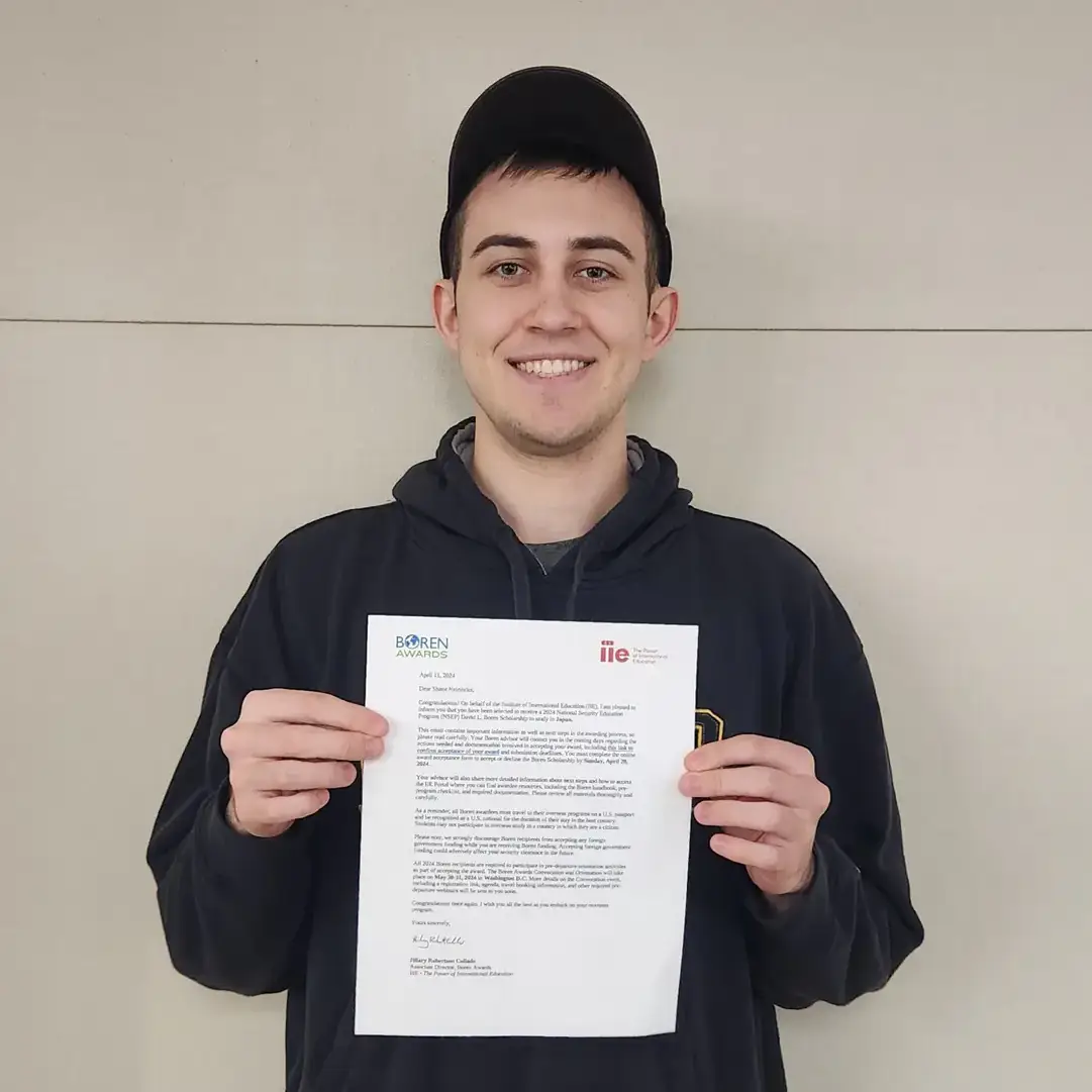 Shane Neirinckx holds his scholarship award letter