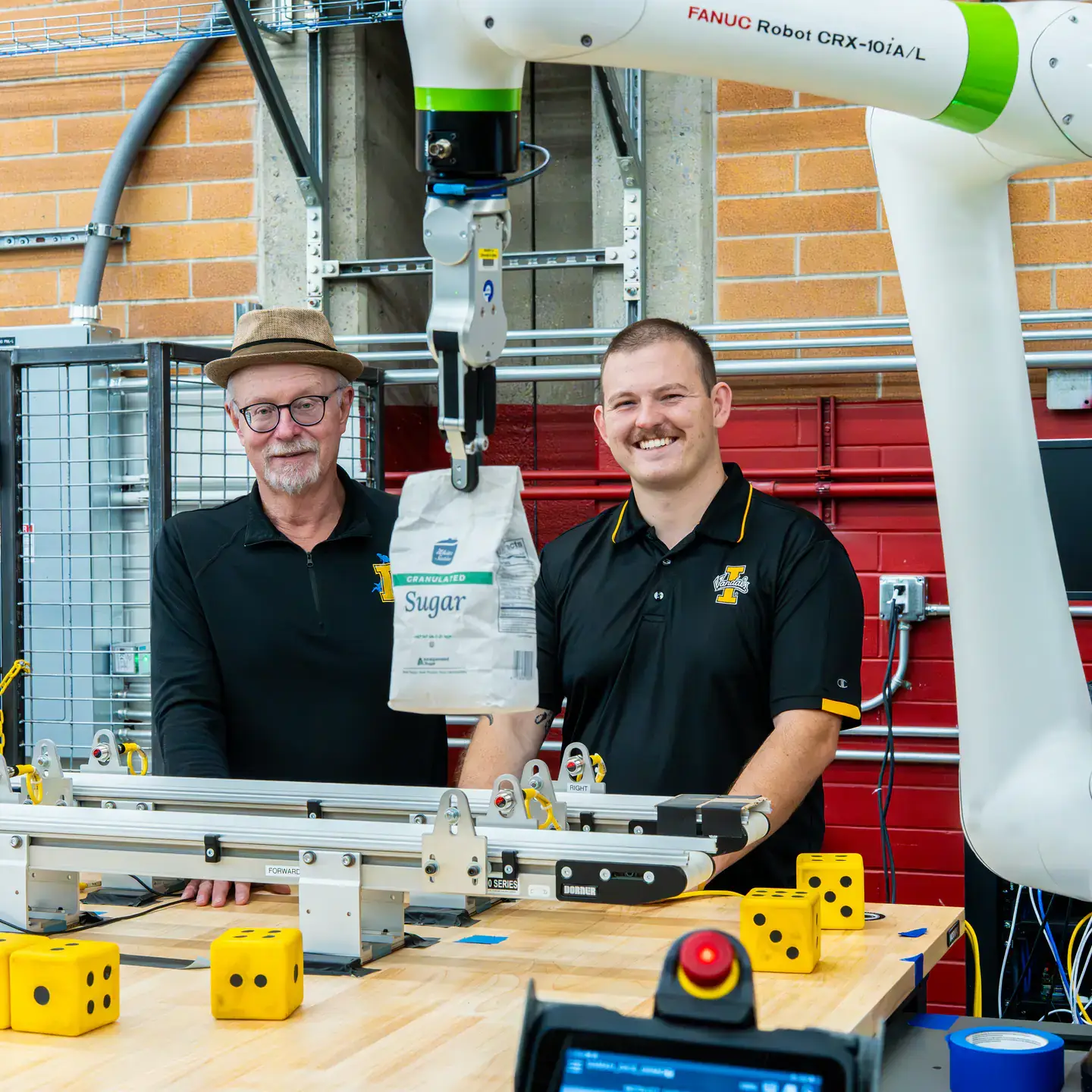 Engineering students and faculty are developing AI-driven automation solutions for Amalgamated Sugar to keep the plant's assembly line from breaking down while adding components to maintain moisture levels in sugar beets, helping the company improve productivity and optimizing both quality and quantity. Pictured from left are computer science graduate student Hunter Hawkins and research faculty John Shovic.