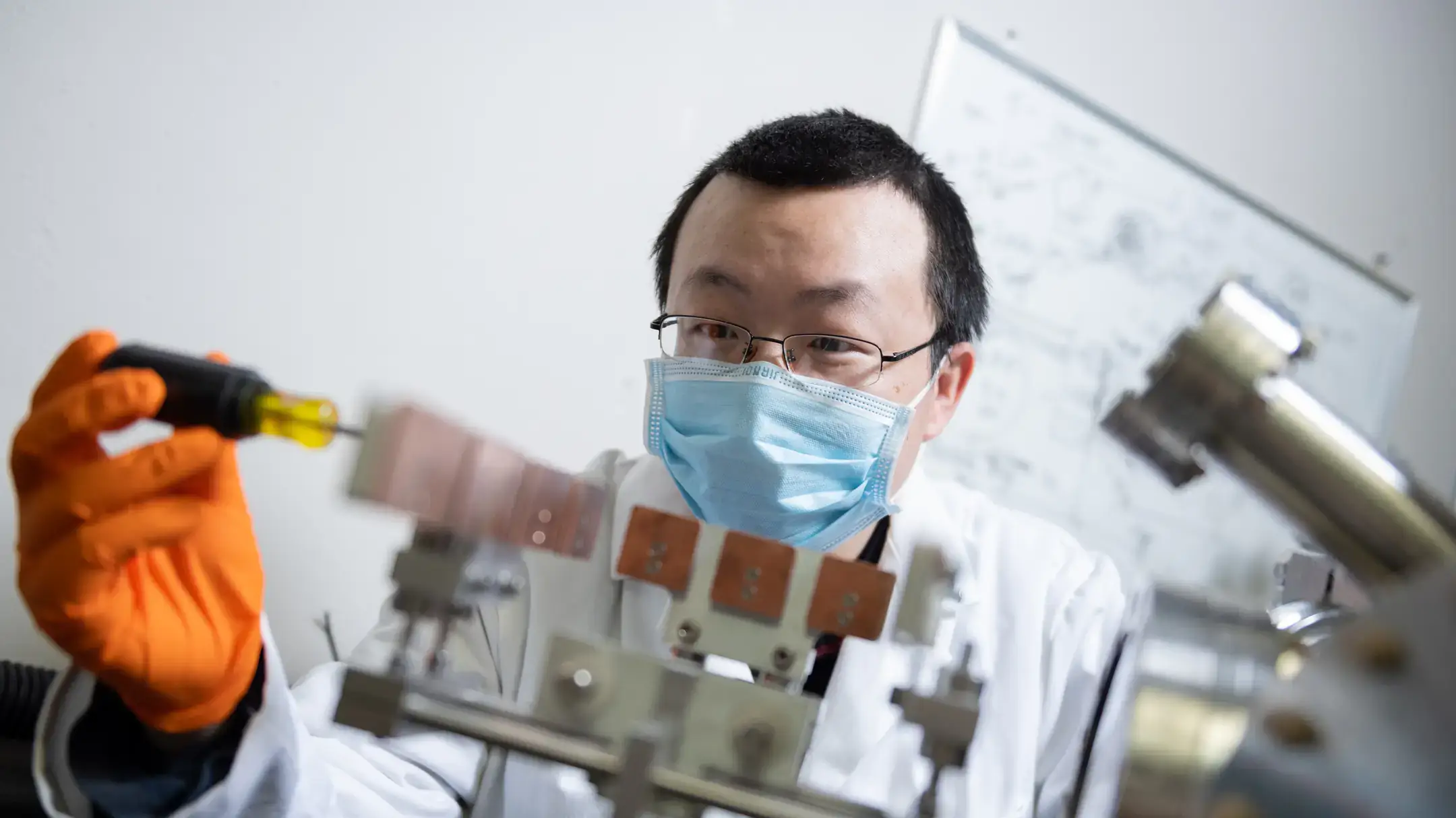 College of Science advanced semi conductor physics students break down and fix Dr. You Qiang's nanotunnel microscope