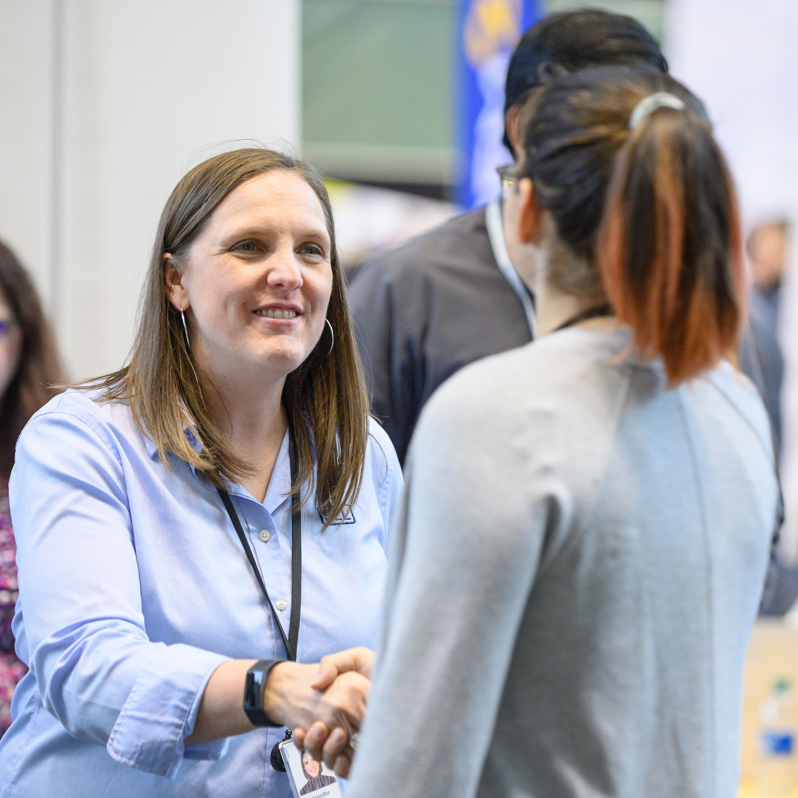 Woman employer talking to student engineer.
