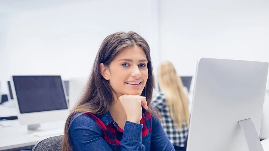Smiling student working on computer