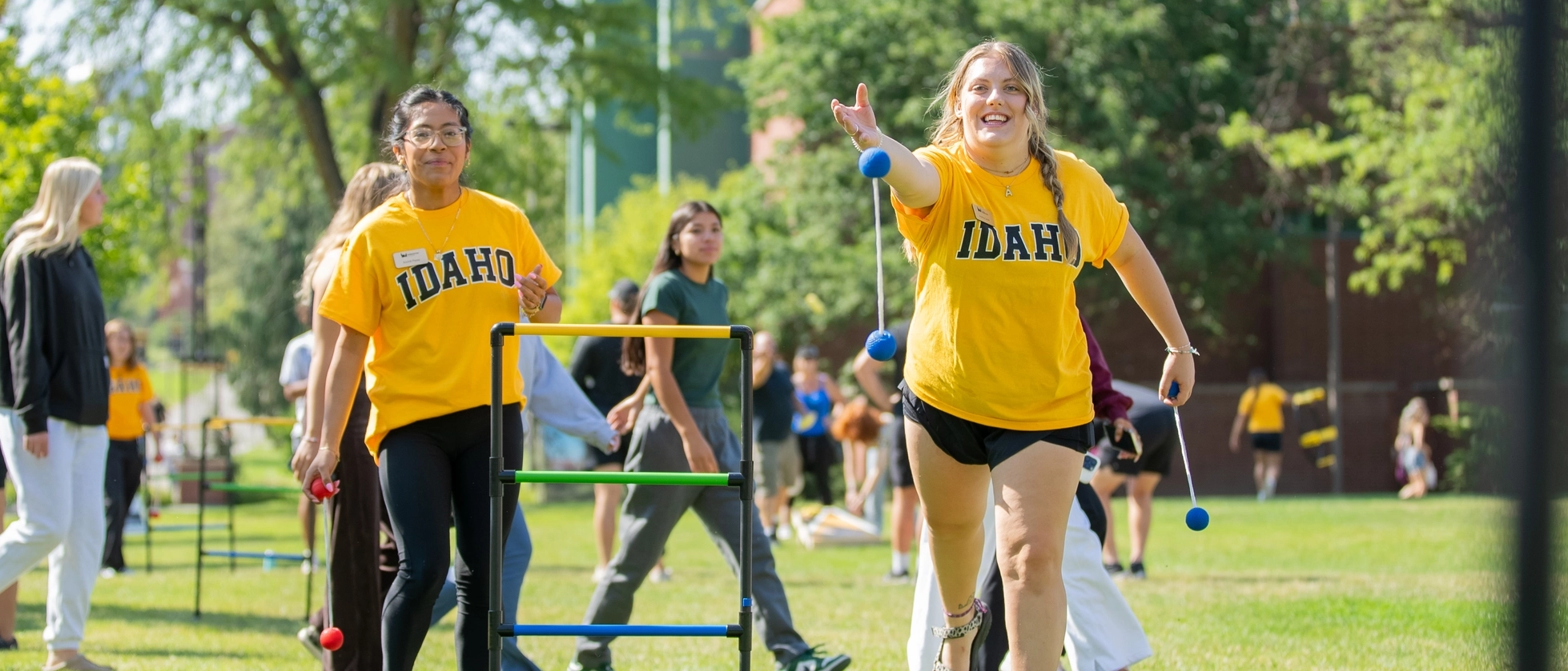 Student play a game on the Theophilus Tower lawn during fall student orientation.