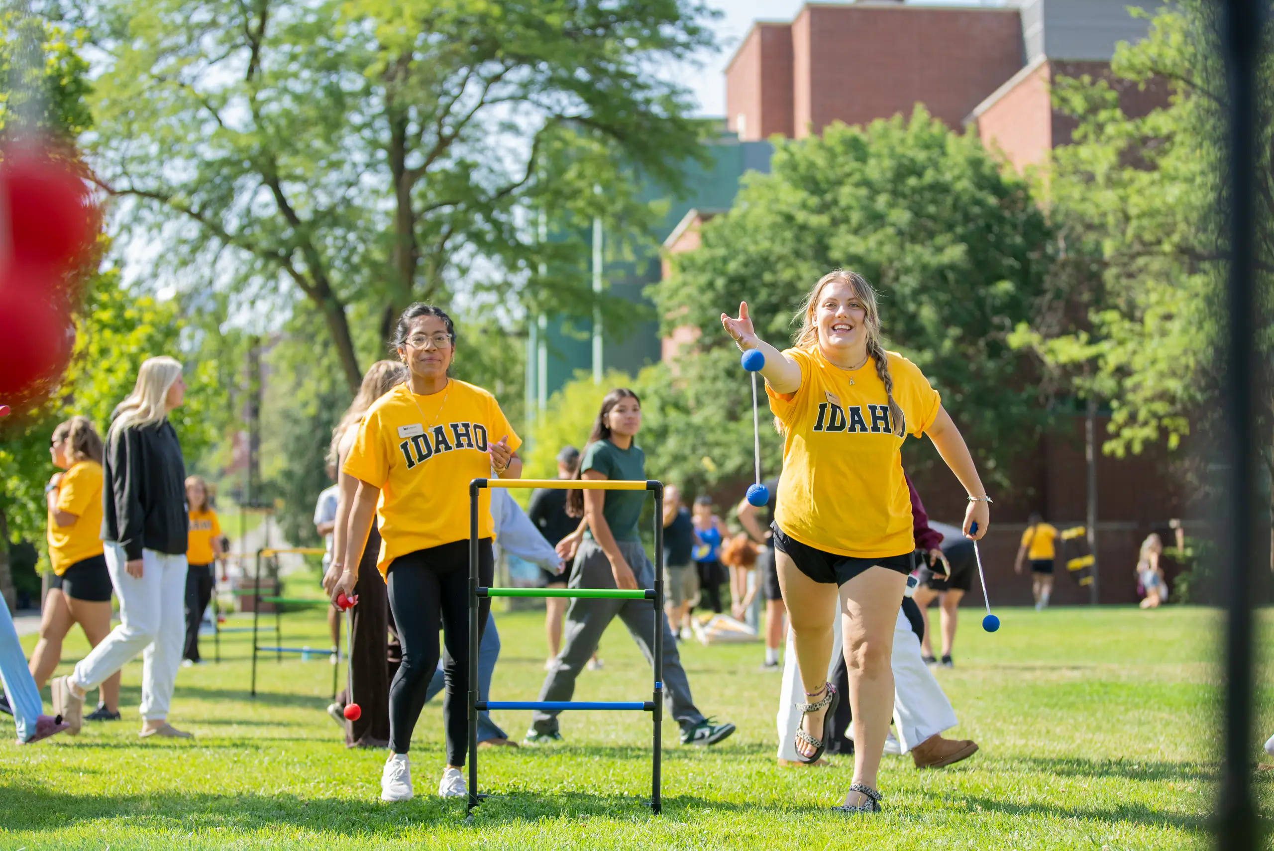 Student play a game on the Theophilus Tower lawn during fall student orientation.
