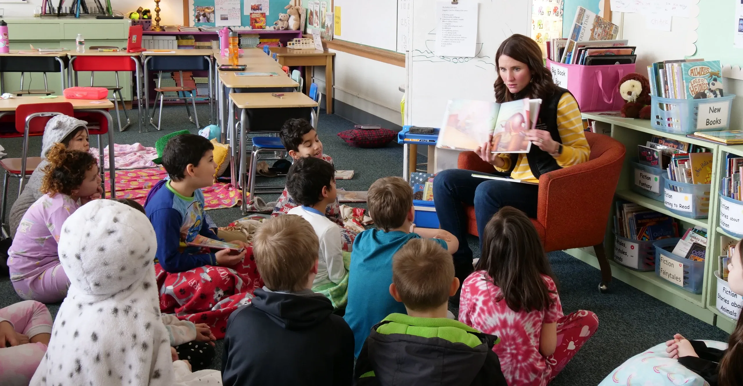Krysta Swanger reads to elementary school students in a classroom.