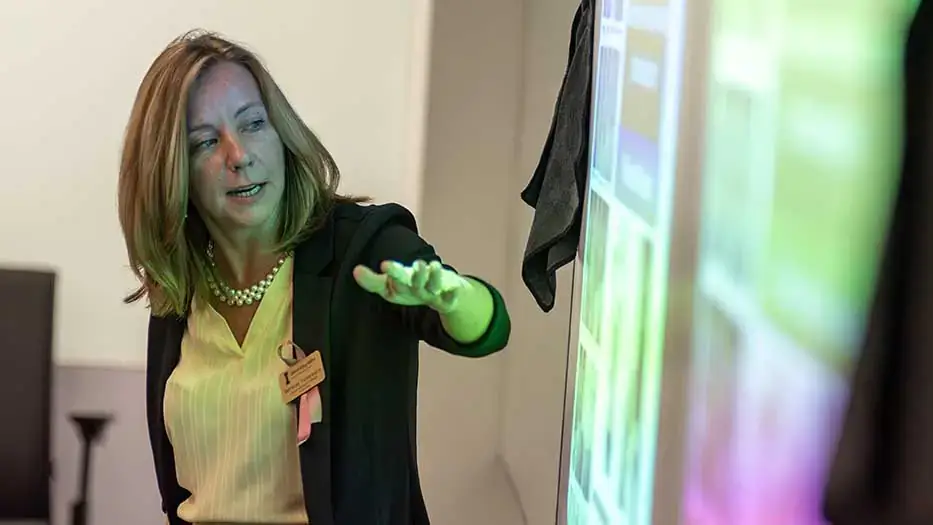 Fehrenkamp stands in front of screen.