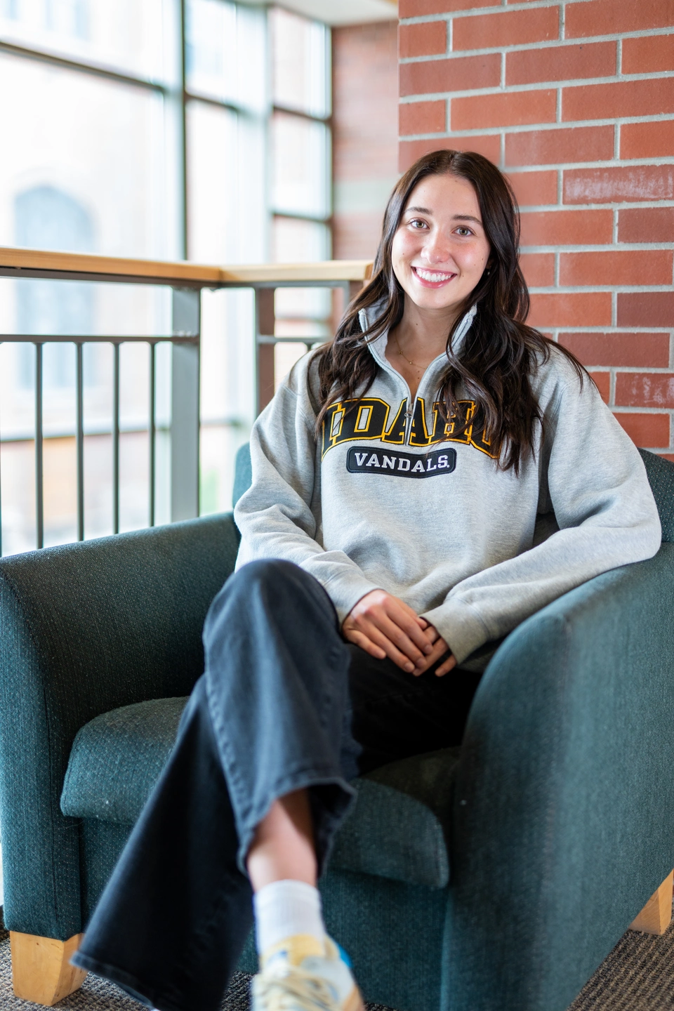 Catherine Hubinger sits in a chair in the Albertsons Building.